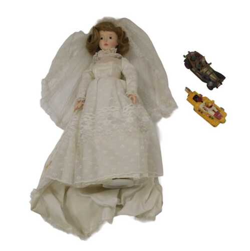 A musical doll on stand, a Corgi Chitty Chitty Bang Bang, and a Corgi The Beatles Yellow...