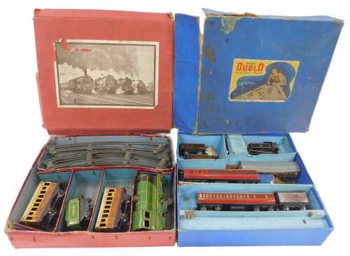A tinplate clockwork O gauge train set, including locomotive, tender, two coaches and track,...