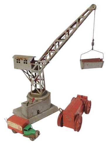 A Tri-ang tinplate tractor, a tinplate crane, and a Minic Transport Road Rail Express Service van.