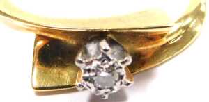 A diamond solitaire ring, in a cross over setting, yellow metal stamped 18ct, size M, 3.3g all in. - 2