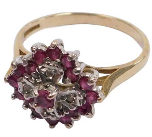 A 9ct gold ruby and diamond flower head ring, in a lozenge claw setting, size R, 3.1g all in.