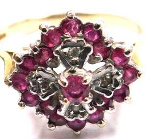 A 9ct gold ruby and diamond flower head ring, in a lozenge claw setting, size R, 3.1g all in. - 2