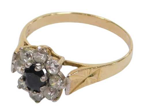 A 9ct gold sapphire and cz flower head ring, in a claw setting, size O, 2.1g all in.