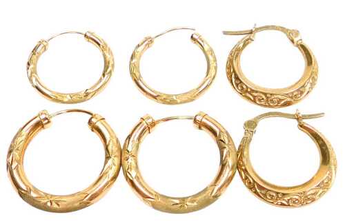 A pair of creole earrings, with engraved foliate decoration, pair of hoop earrings, with...
