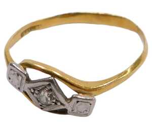 A mid century diamond three stone ring, in a cross over setting, in yellow and white metal...
