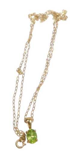A 9ct gold and peridot pendant, on a fine link neck chain, with bolt ring clasp, stamped 9ct, 1.1g.