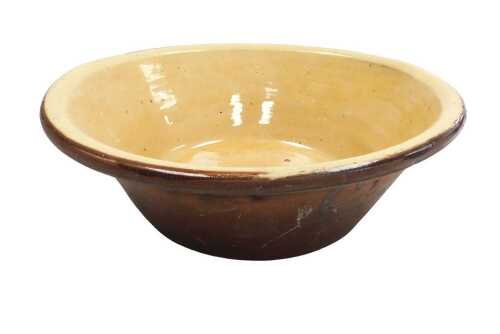 A late 19thC terracotta and cream glazed dairy bowl, 36cm wide.