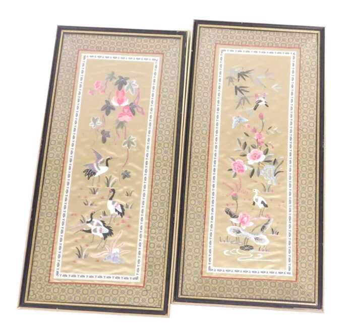 A pair of 20thC Chinese silkwork pictures, of flowers and cranes, each within a diaper work...