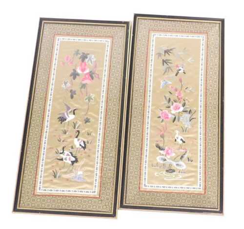 A pair of 20thC Chinese silkwork pictures, of flowers and cranes, each within a diaper work...