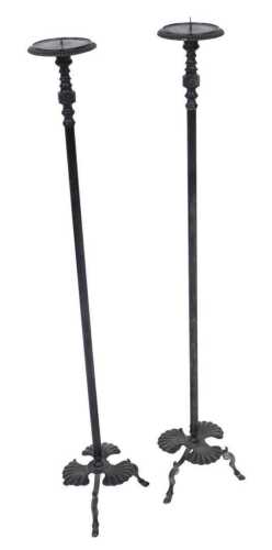 A pair of late 19thC French ebonised brass pricket candle holders, each raised on a three leaf...