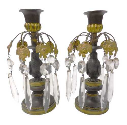 A pair of late 19thC French bronze and ormolu candlesticks, each with eight curving branches,...
