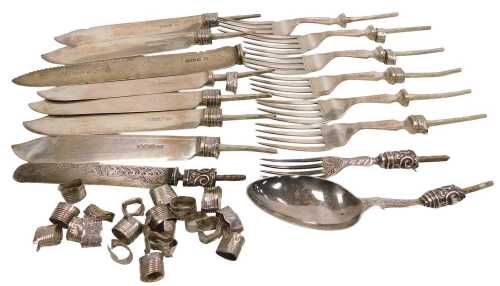 A group of scrap silver fish knife, forks and blades, spoons, etc., with metal cores, and silver...