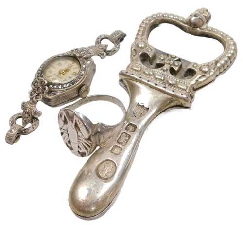 An Elizabeth II silver bottle opener, of crown form, London 1953, 1.39oz, together with a silver...