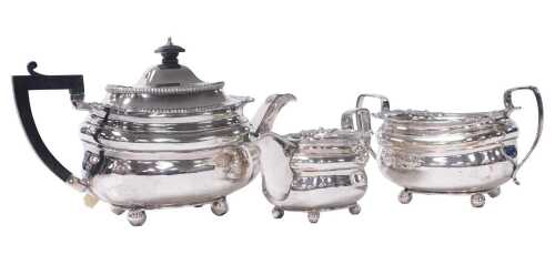 An early 19thC Old Sheffield plate three piece tea set, of bombe form, the rim gadrooned with...