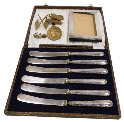 A set of six George V silver handled cake knives, cased, Sheffield 1929, together with a silver...