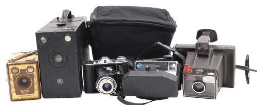 A Houghton Ensign box camera, Kodak Brownie 6-20 camera, model F, Polaroid Super Swinger land...