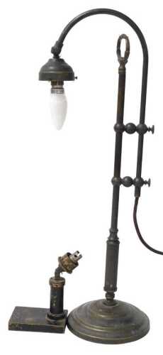 An early 20thC brass desk lamp, with a curved arm, raised on a stepped circular base, 61cm high,...