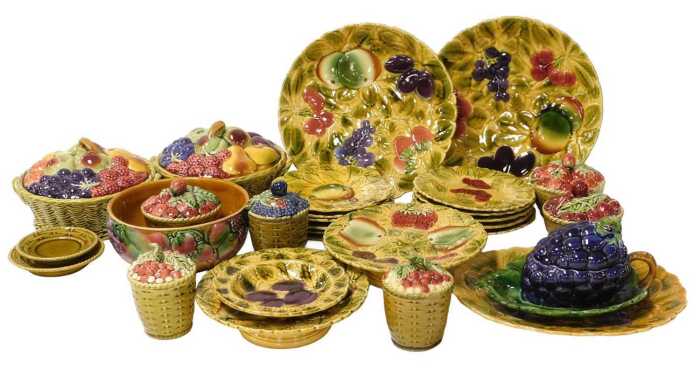 A group of early 20thC Sarreguemines pottery, relief decorated with fruit, including preserve...