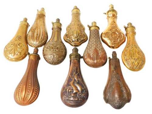 Ten 19thC copper power flasks, all with embossed decoration, including two examples by James...