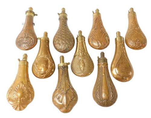 Ten 19thC copper and brass powder flasks, all with embossed decoration, including three examples...