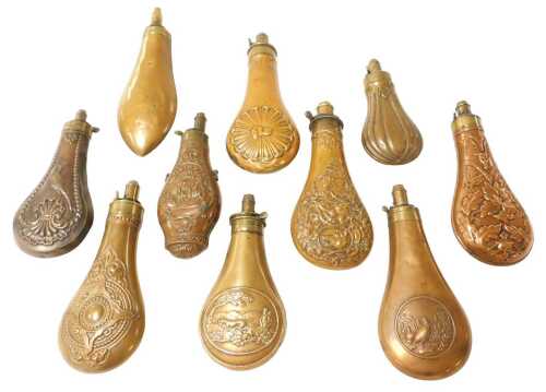 Ten 19thC copper and brass powder flasks, most with embossed decoration including two examples...