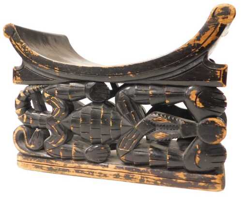 An ebonised wooden Cameroon Duala stool, carved with a crocodile to each side, 36cm high, 52cm...