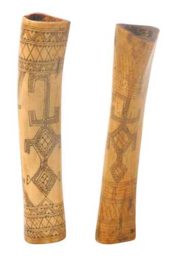 An Indonesian tribal lime container, West Timor, carved with a stylised crocodile to the front...