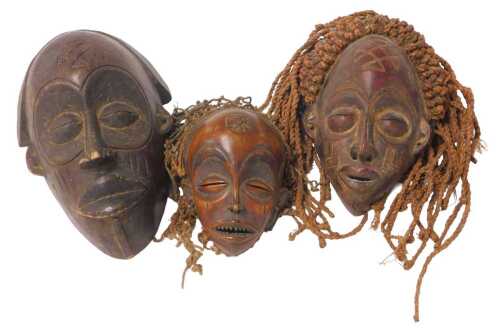 An African Chokwe tribal mask, painted in red with rope hair, 34cm high, a larger Chokwe mask...