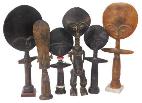 An Ashanti carved wooden fertility figure, on a marble base, 45.5cm high, and five others.