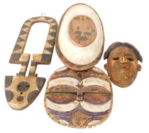 A Dogon Kanaga tribal mask, decorated in black and white, 64cm high, two African tribal shields...