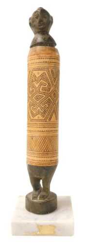 An Indonesian carved bamboo lime powder container, in the form of a figure on a later marble...