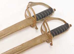 A pair of cavalry sabres, with a steel guard, and a wire bound black leather grip, curved blade... - 2