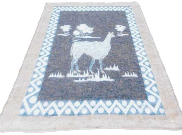A late 20thC South African llama wool blanket, decorated with a llama and trees, within a...