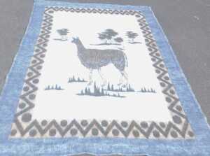 A late 20thC South African llama wool blanket, decorated with a llama and trees, within a... - 2
