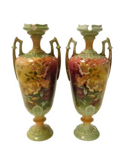 A pair of Continental ceramic two handled vases, each decorated in Worcestr style with flowers,...