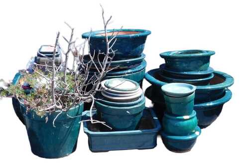 A group of terracotta and other green glaze plant pots and bonsai pots, of differing size and...