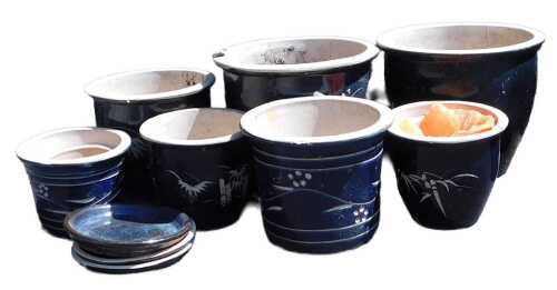 A group of dark blue glaze plant pots, with incised bamboo and floral decoration, the largest...