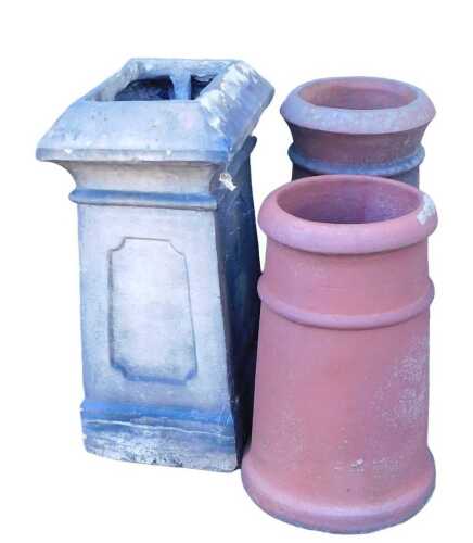 Two terracotta chimney pots, each of cylindrical form, 54cm high and 47cm high, together with a...