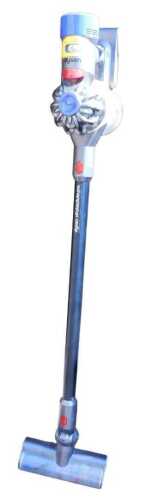 A Dyson V8 Absolute Pro cordless stick vacuum cleaner, with charging cable and accessories.