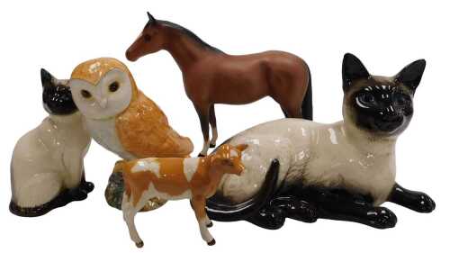 A small group of Beswick pottery, including two Siamese cat, number 1559 and 1887, barn owl,...