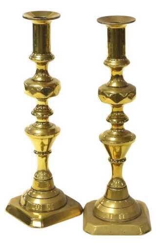 A pair of Victorian brass ejector candlesticks, with faceted knop stems, 30cm high.