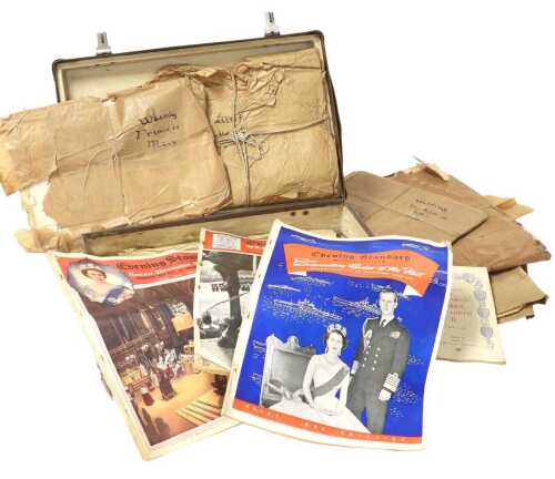 A vintage suitcase containing a collection of newspapers the British Royal Family, including...