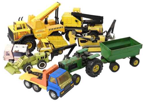 A collection of Tonka toy vehicles, including tractor and trailer, bulldozer, digger, two cranes,...