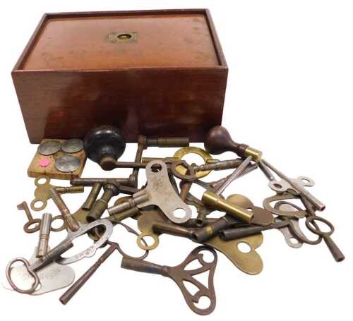 A collection of various clock keys, including long case clock keys, and a Victorian mahogany box...