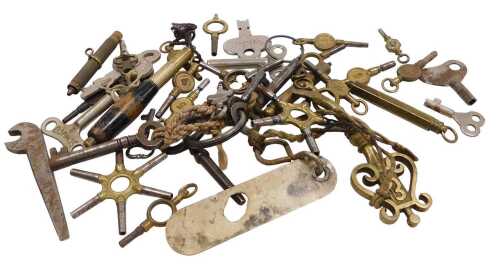 A collection of antique watch keys, including a universal sprung loaded key for Kendal & Dent,...