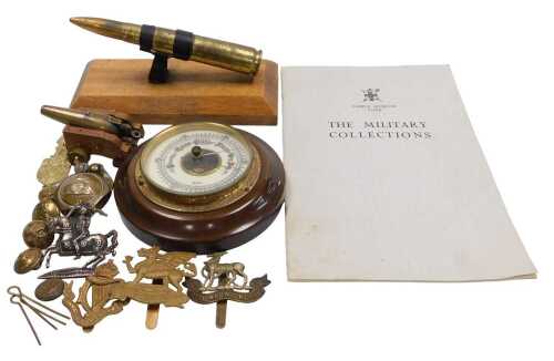 Military interest, including cap badges, buttons, miniature cannon, barometer, etc.