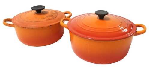 Two Le Creuset volcano orange enamelled cast iron casserole pots with lids, 21cm diameter and...