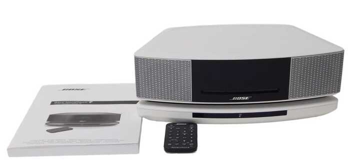 A Bose Wave SoundTouch music system, series IV, with remote and instructions.
