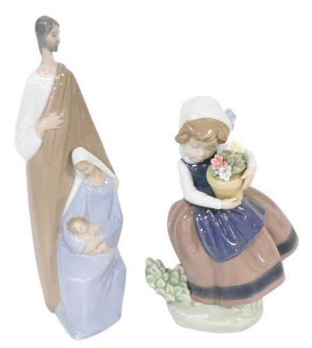 A Lladro porcelain figure group, modelled as Joseph, Mary and Christ, 22cm high, together with a...