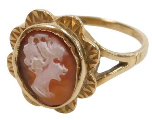 A 9ct gold cameo dress ring, the oval cameo depicting maiden's head, in a petalated border, on V...